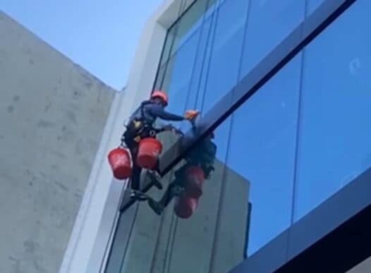 Certified rope-access technician working at height